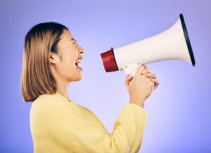 Megaphone, voice and young woman with human rights, equality and freedom of speech or strong opinio