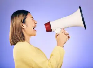 Megaphone, voice and young woman with human rights, equality and freedom of speech or strong opinio