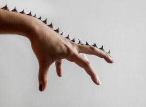 Spikes on hand on white background