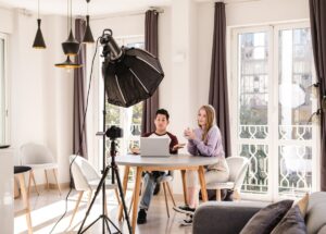 video bloggers making a video with a professional camera on a tripod at home.